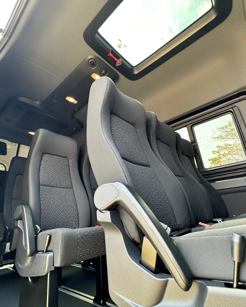 Comfortable seats and a skylight inside one of our vans